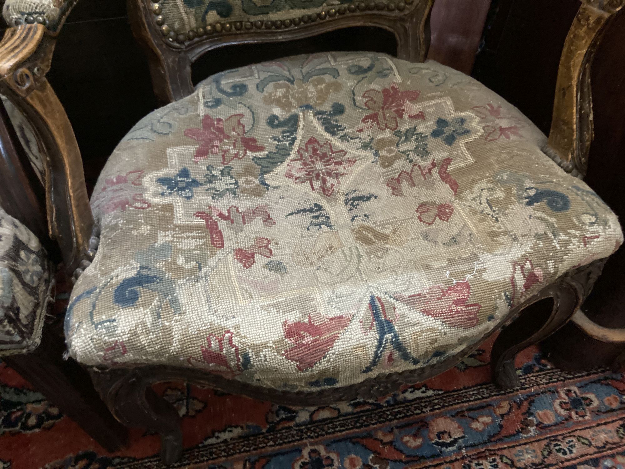 A Hepplewhite style mahogany armchair and a Louis XV walnut fauteuil covered in tapestry